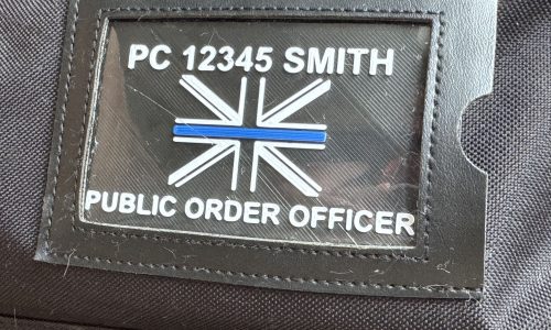 Kit Bag Window for a Public Order PC with a Thin Blue Line flag, inside a kit bag window Kit Bag Window for a Public Order PC with a Thin Blue Line flag, inside a kit bag window
